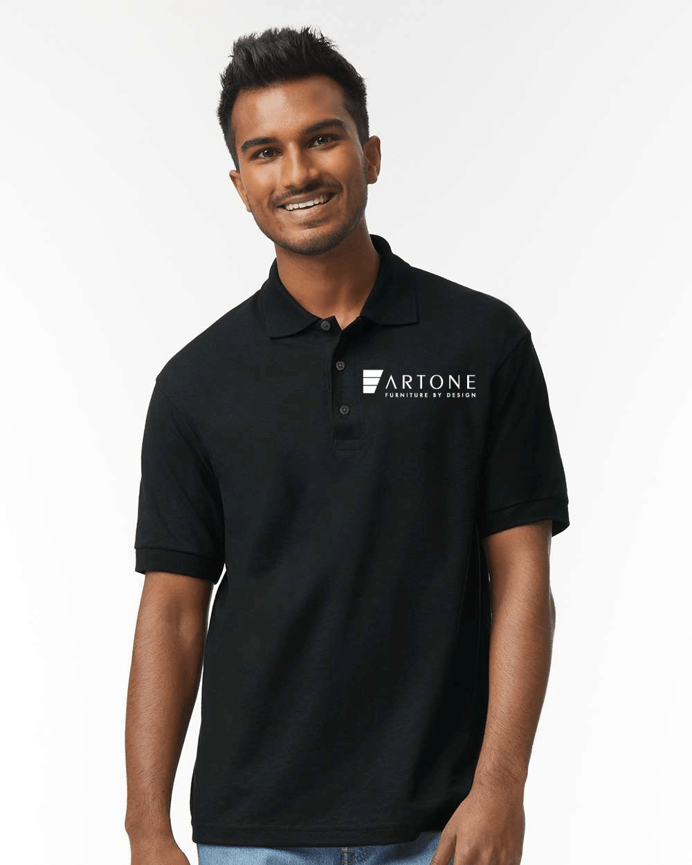 Gildan - Unisex DryBlend® Jersey Polo - 8800 (Artone) 1 Male model smiling while wearing a custom black Gildan 8800 polo shirt with the 'Artone Furniture by Design' logo on the left chest.