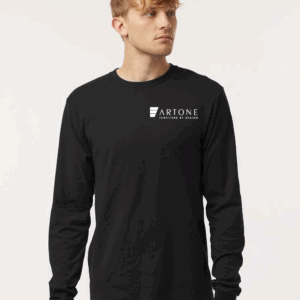 Male model showcasing a custom black Tultex 202LS long-sleeve t-shirt with the white 'Artone Furniture by Design' logo on the left chest.