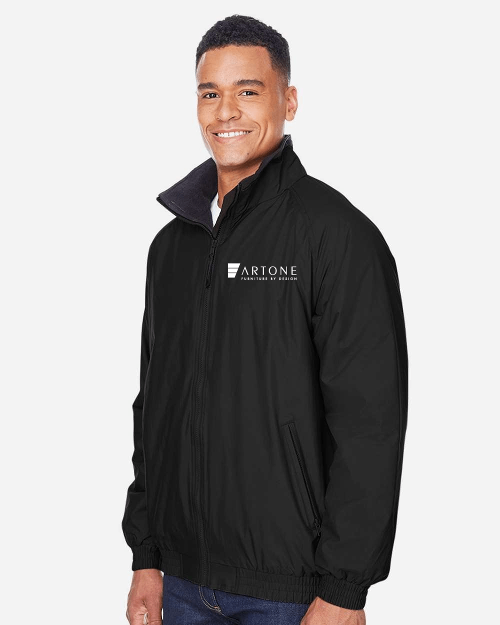 Harriton - Unisex Fleece Lined Nylon Jacket - M740 (Artone) 2 Male model smiling while wearing a custom black Harriton M740 fleece-lined jacket with the 'Artone Furniture by Design' logo on the left chest.