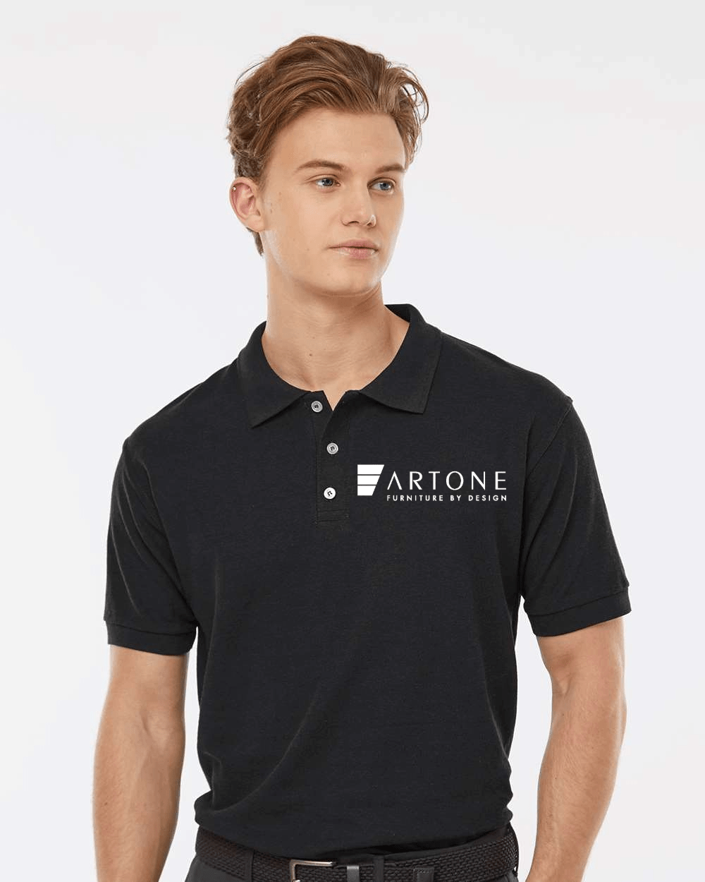 Tultex - Men's 50/50 Sport Pique Polo - 400 (Artone) 1 Male model showcasing a custom black Tultex 400 polo shirt with the 'Artone Furniture by Design' logo on the left chest.